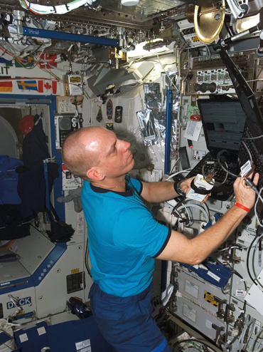 Clayton Anderson at work aboard the International Space Station.