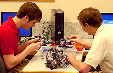 Nick Gradoville, left, and Ross Friedman, students at Kuemper Catholic High School in Carroll, work on the robot they'll enter in the IT-Olympics at Iowa State University.