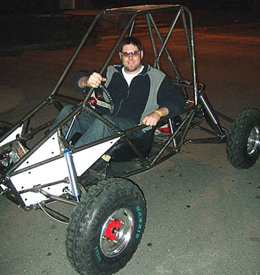 Dain Sires of Iowa State's Mini Baja Team poses with the car during one of its first tests.