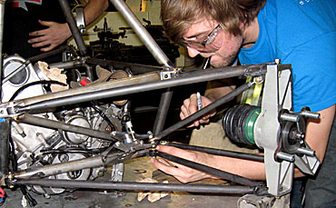 Kyle Anderson of Iowa State's Formula SAE Team works on this year's race car.