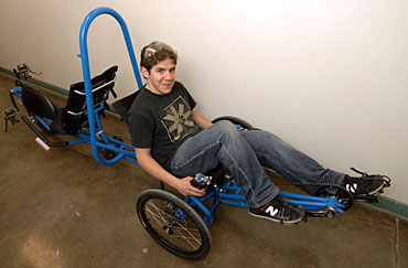 Sam Bergus demonstrates the human powered vehicle designed and built by Iowa State students.
