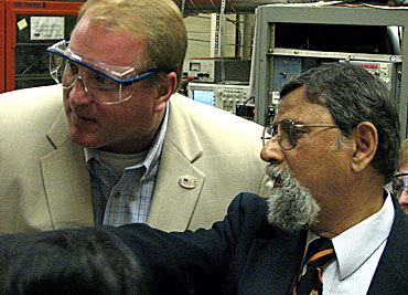 Iowa Gov. Chet Culver, left, examines a plasma reactor at Iowa State University's Microelectronics Research Center. Vikram Dalal, the director of the center, told the governor how plasma is used to fabricate thin film for solar cells. 