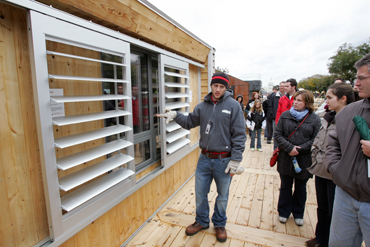 Updates Isu Students Solar House Competes In Doe Decathlon Iowa State Student Thomas Dillman Shows Visitors The Adjule Window Louvers Used To Prevent Direct Heat Gain On His Team S Solar Ed House During